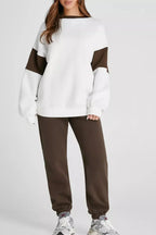 Women wearing an oversized drop shoulder sweatshirt and matching jogger pants from Trendsi loungewear set, comfortable and casual.