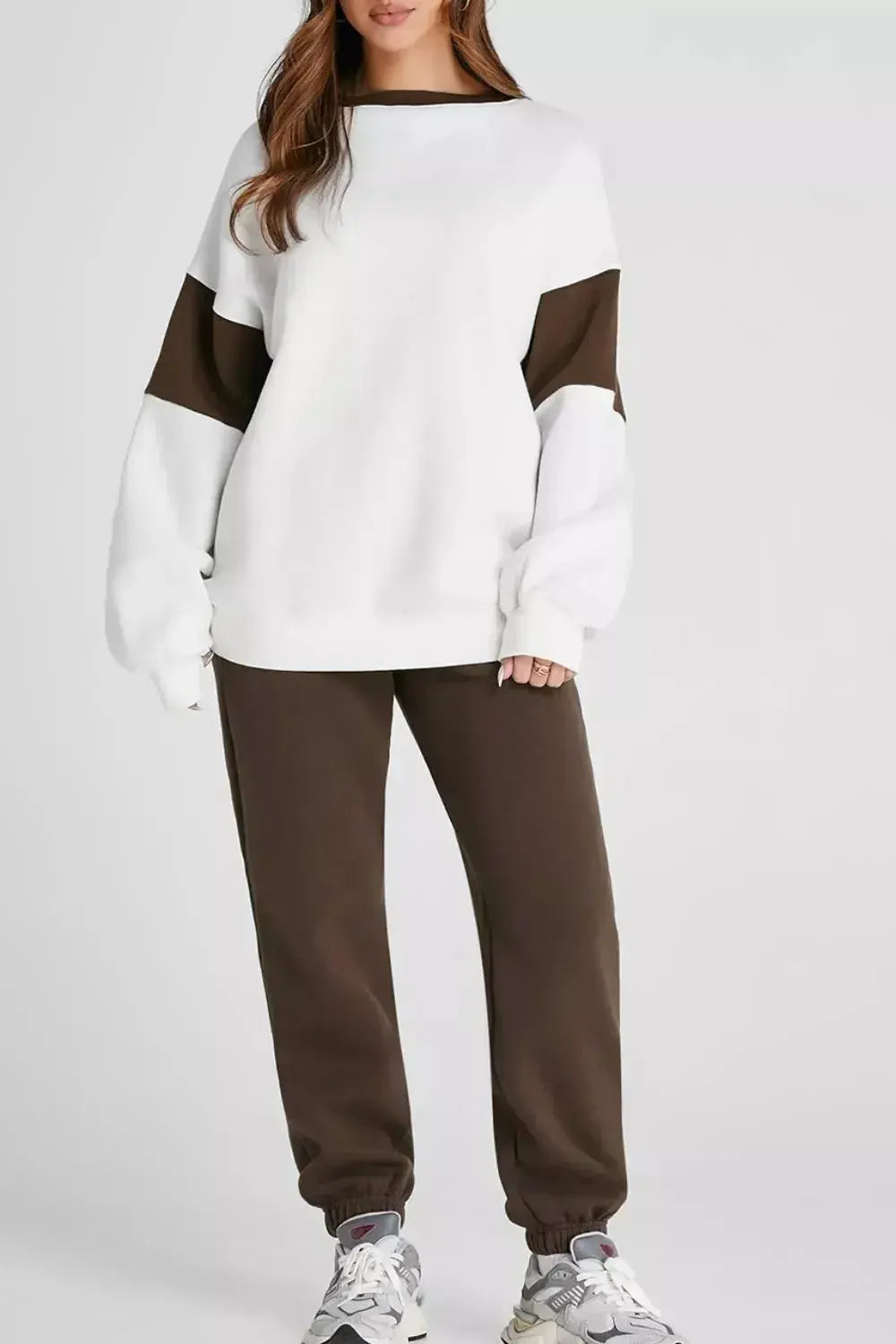 Women wearing an oversized drop shoulder sweatshirt and matching jogger pants from Trendsi loungewear set, comfortable and casual.