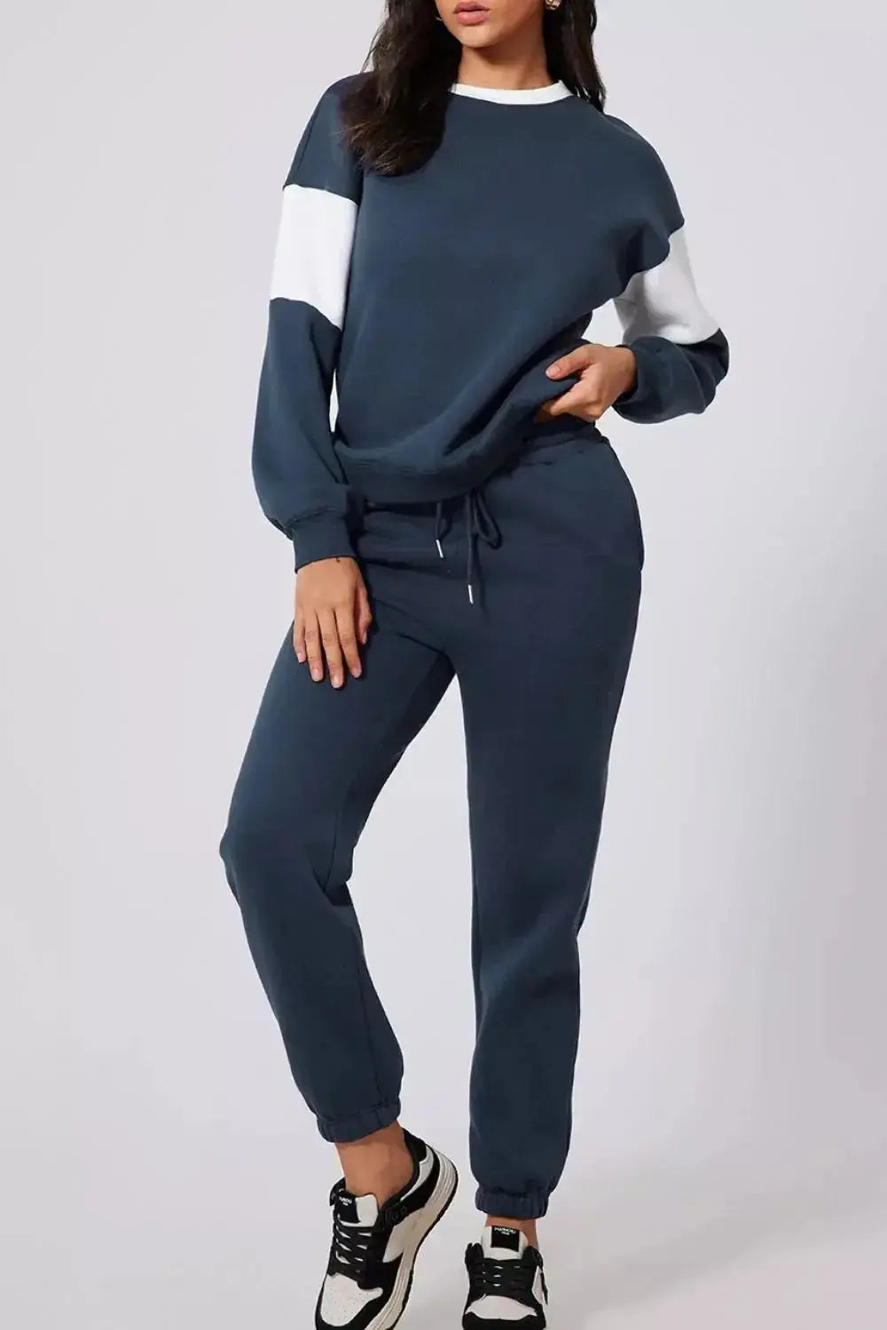 Women’s oversized drop shoulder sweatshirt and matching joggers loungewear set by Trendsi, casual comfortable style.