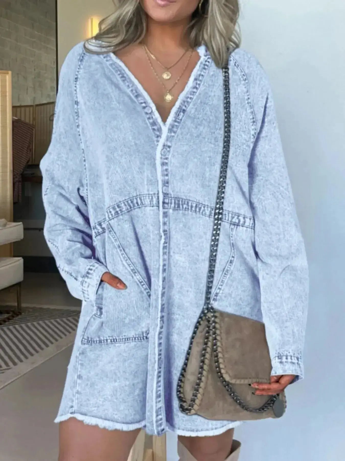 Women’s oversized long sleeve denim shirt dress with pockets, stylish casual denim dress by Trendsi, showing front view with pockets.