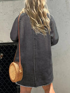 Women’s oversized long sleeve denim shirt dress with front pockets, casual style by Trendsi, shown in a relaxed fit with denim fabric.