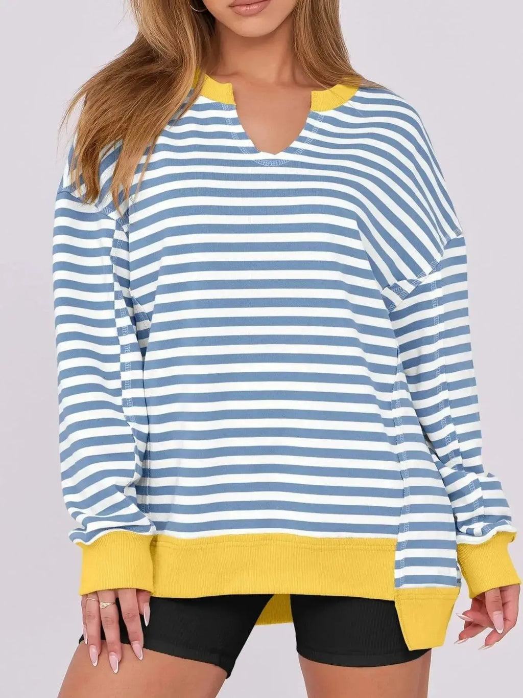 Women’s oversized notched neck sweatshirt with contrast stitching, casual sweater from Trendsi, shown with relaxed fit and stylish details.