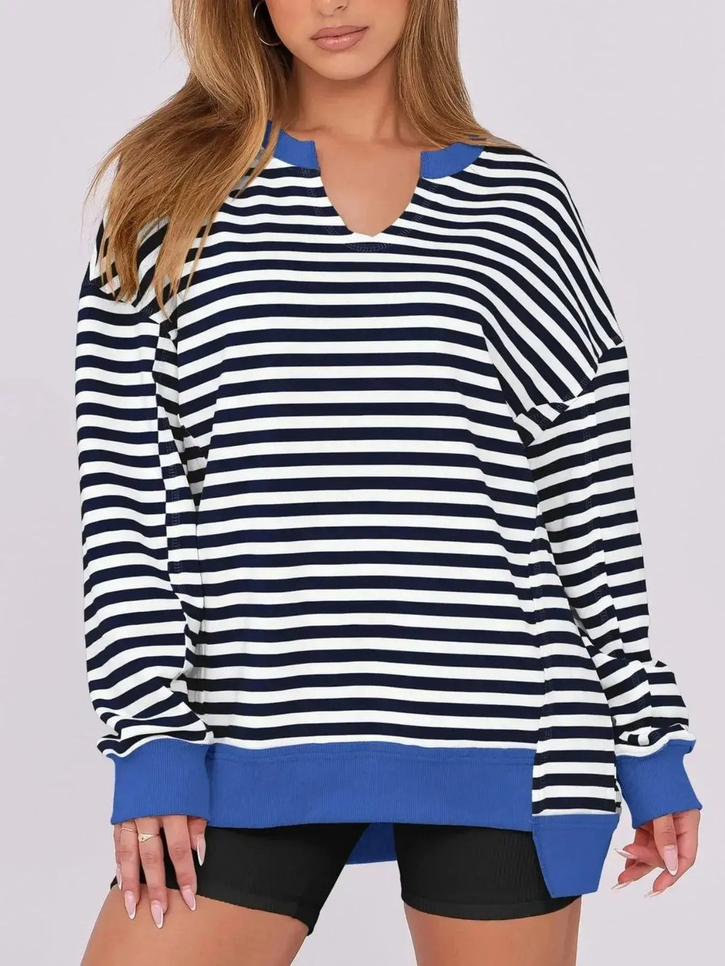 Women’s oversized notched neck sweatshirt with contrast stitching, casual sweater by Trendsi, featuring a relaxed fit and stylish design.