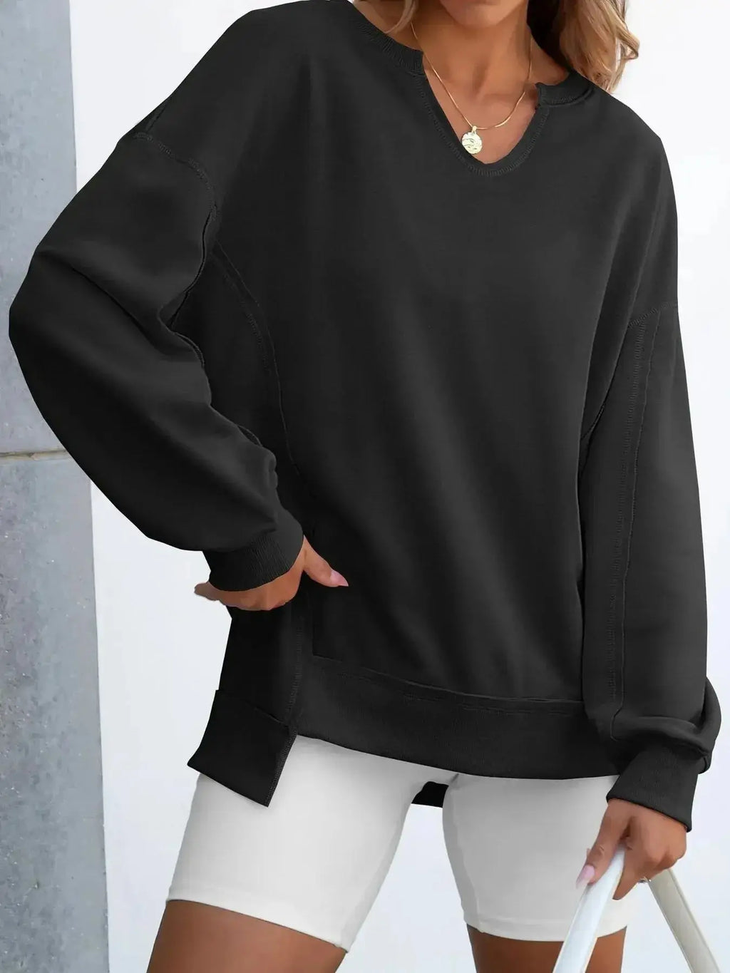 Women's oversized sweatshirt with notched neckline and contrast stitching, stylish and comfortable sweater from Trendsi.
