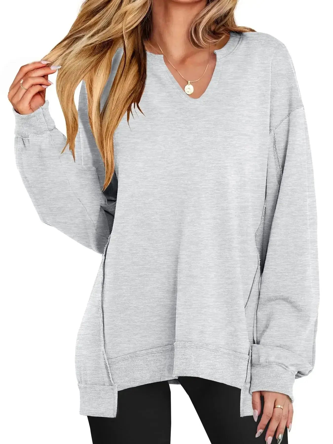 Women’s oversized notched neck sweatshirt with contrast stitching, casual sweater by Trendsi, featuring a relaxed fit and stylish design.
