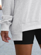Women’s oversized notched neck sweatshirt with contrast stitching, stylish sweater from Trendsi, featuring a relaxed fit and unique neckline.