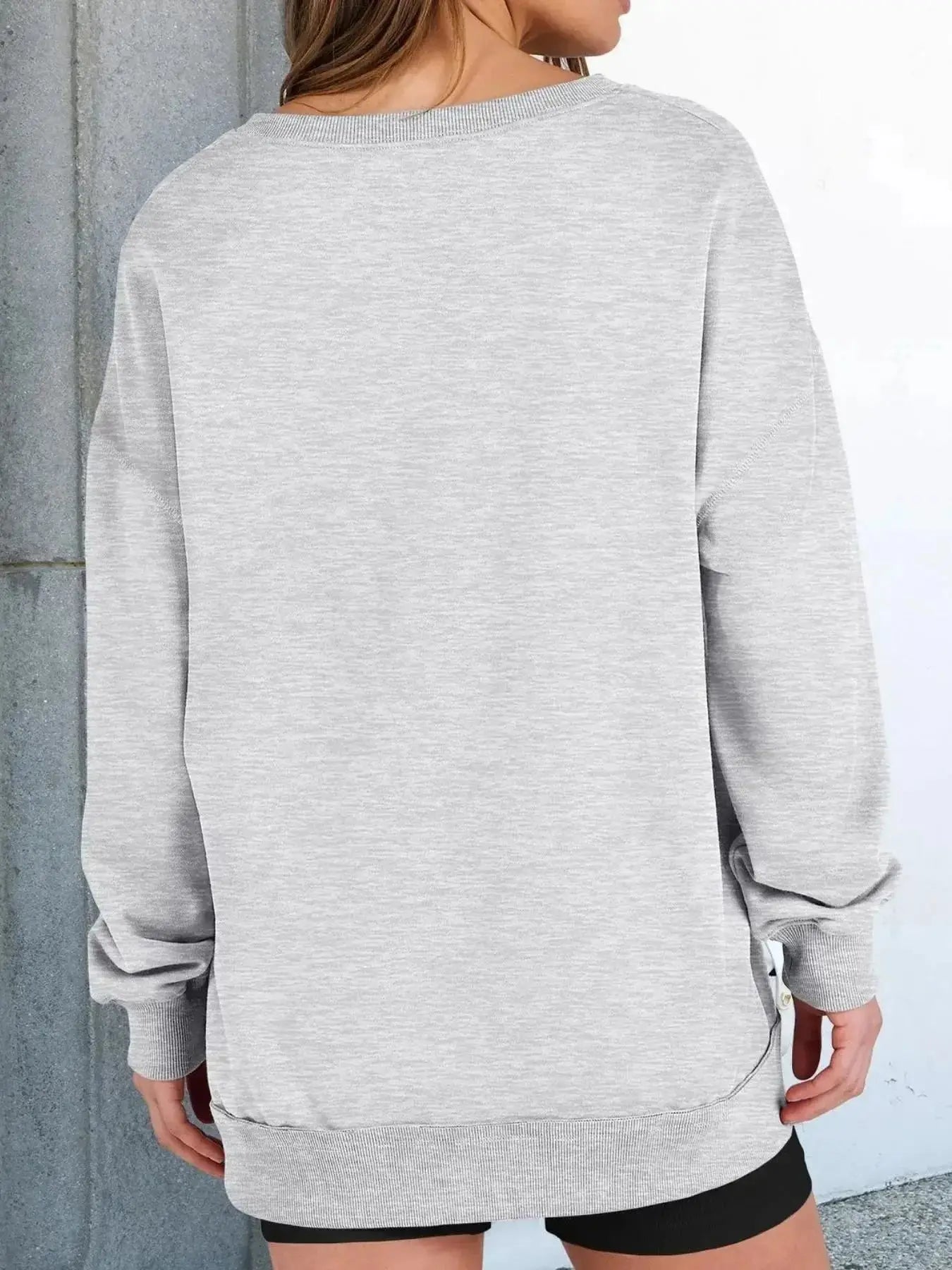 Women’s oversized sweatshirt with notched neck and contrast stitching, stylish and comfortable sweater from Trendsi.