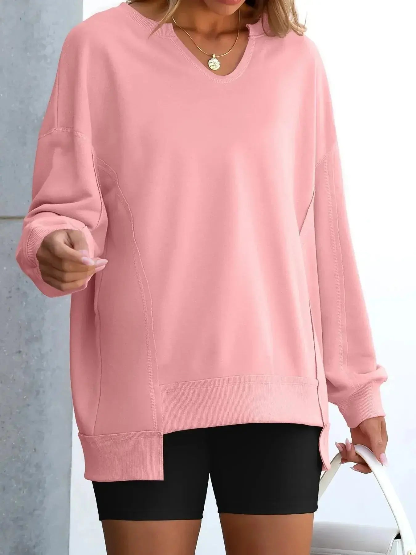 Women’s oversized notched neck sweatshirt with contrast stitching, stylish sweater from Trendsi, featuring a relaxed fit and unique neckline.
