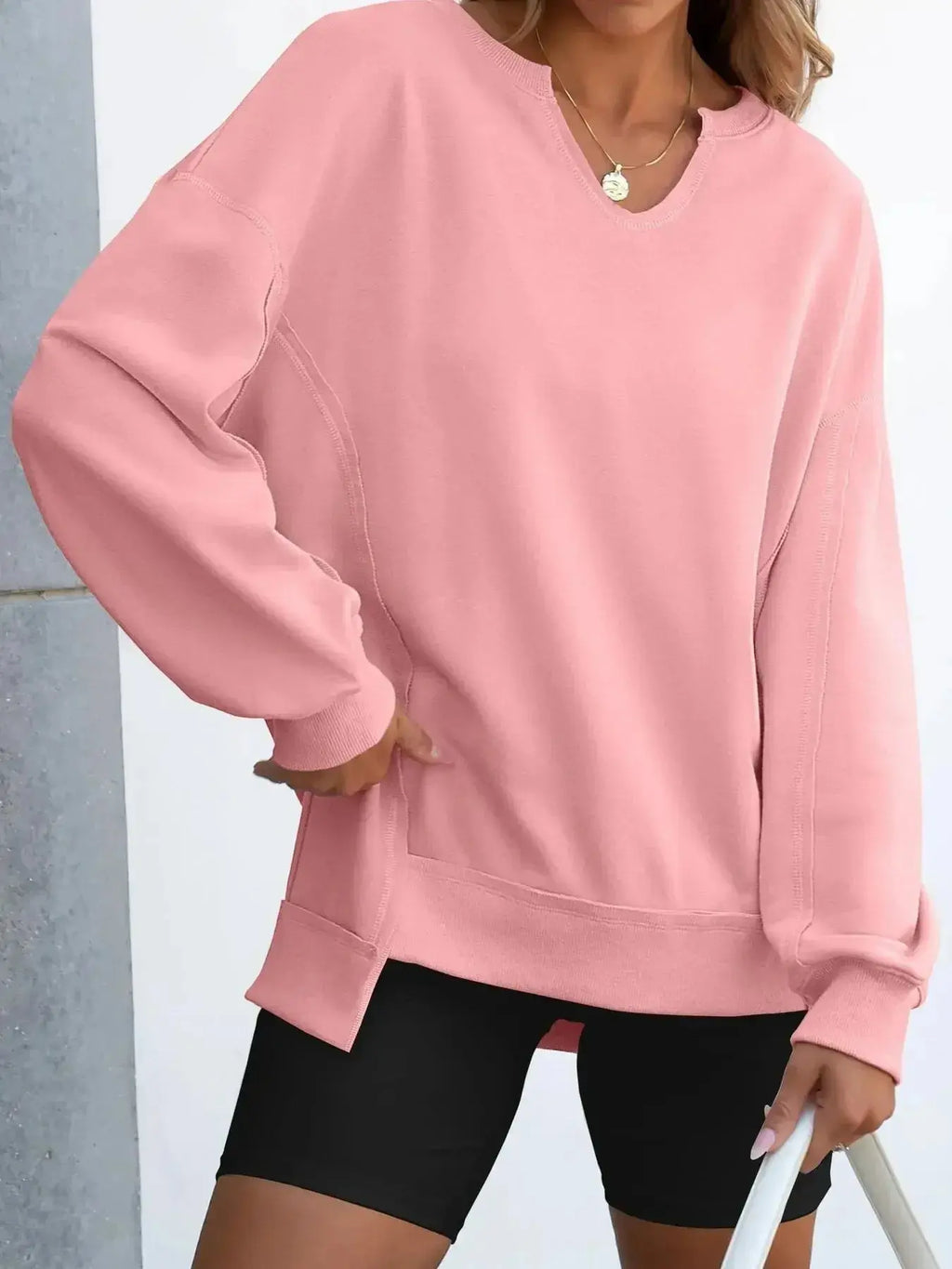 Women's oversized notched neck sweatshirt with contrast stitching, stylish sweater from Trendsi, featuring a relaxed fit and cozy fabric.