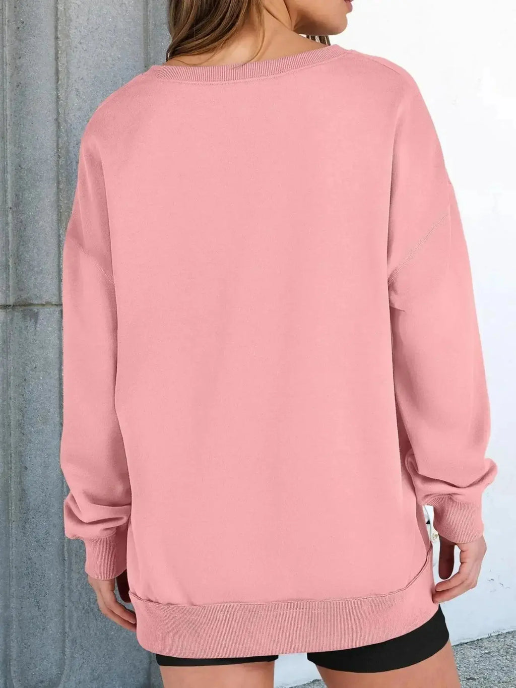 Women’s oversized notched neck sweatshirt with contrast stitching from Trendsi, showing a relaxed fit and stylish design.