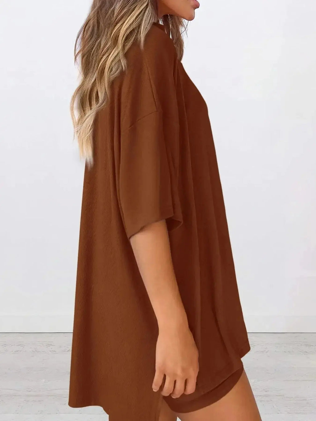 Women's oversized round neck loungewear set by Trendsi, featuring a comfortable two-piece shirt and lounge pants.
