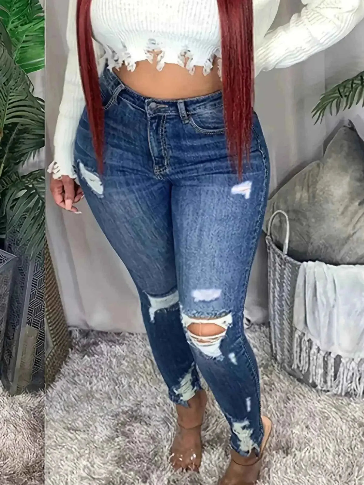 Plus size distressed slim fit jeans with raw hem by Plush Fashion Hub, shown on a woman, casual denim style