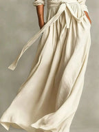 Plus size women's long sleeve maxi dress with tie waist and pockets, featuring a comfortable, stylish design by Trendsi.