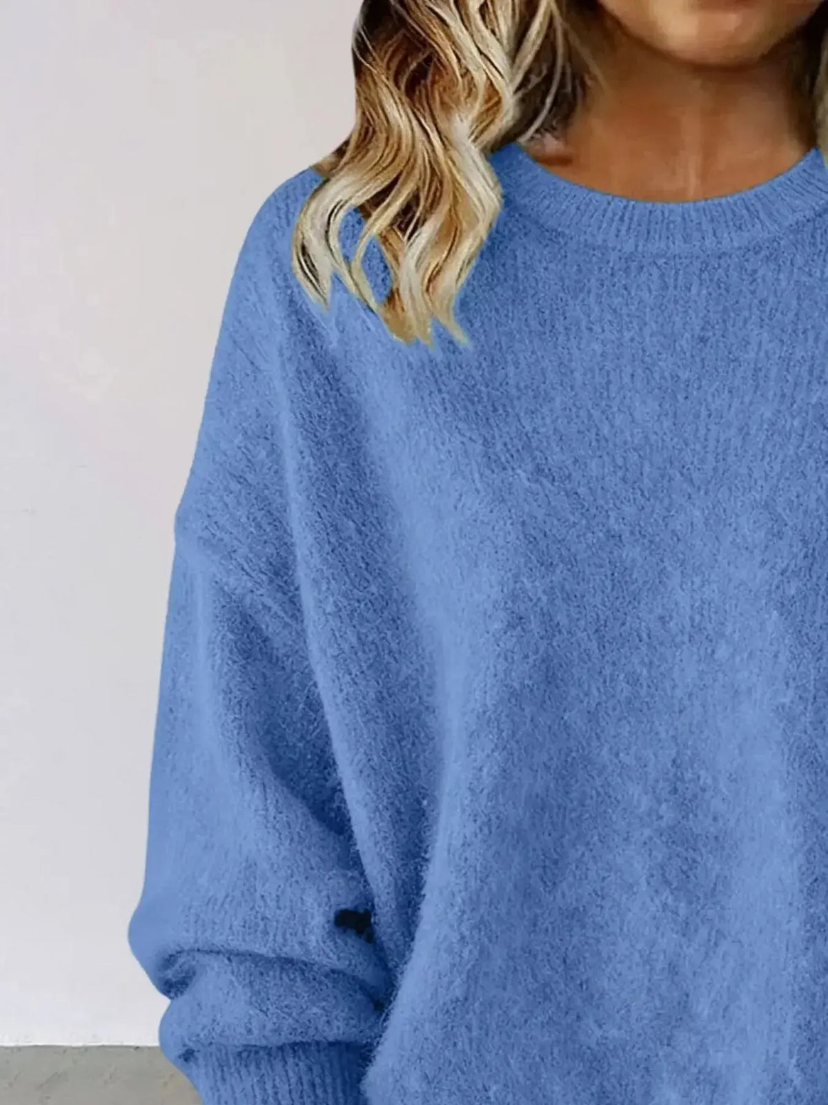 Plus size women's relaxed fit sweater with dropped shoulders and round neckline, in soft knit fabric by Plush Fashion Hub.