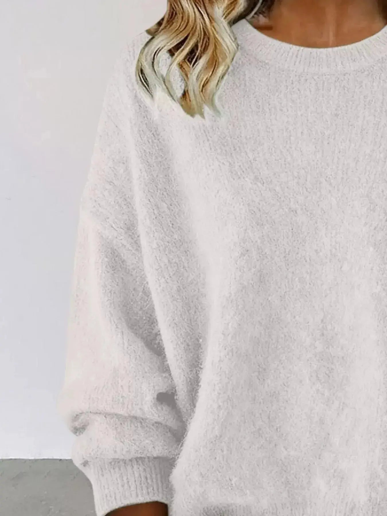 Plus size women's relaxed fit sweater with dropped shoulders and round neck, from Trendsi, stylish and comfortable knit sweater.