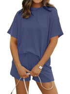 Plus size women's ribbed pajama top and shorts lounge set by Trendsi, featuring short sleeves and comfortable fabric.