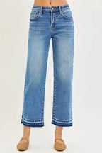 Plus size women's slouchy cropped boyfriend jeans with distressed details and raw hem, made of denim by Trendsi.