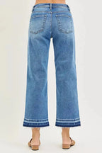 Plus size women's slouchy cropped boyfriend jeans with distressed details and raw hem, made from denim by Trendsi.