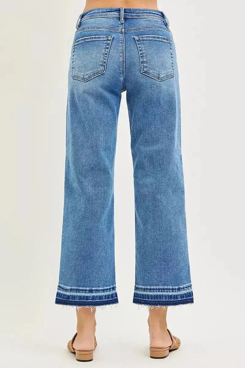 Plus size women's slouchy cropped boyfriend jeans with distressed details and raw hem, made from denim by Trendsi.