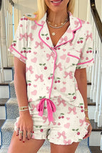 Women's printed button-up short sleeve pajama top and shorts lounge set by Trendsi, featuring a comfortable, stylish sleepwear design.
