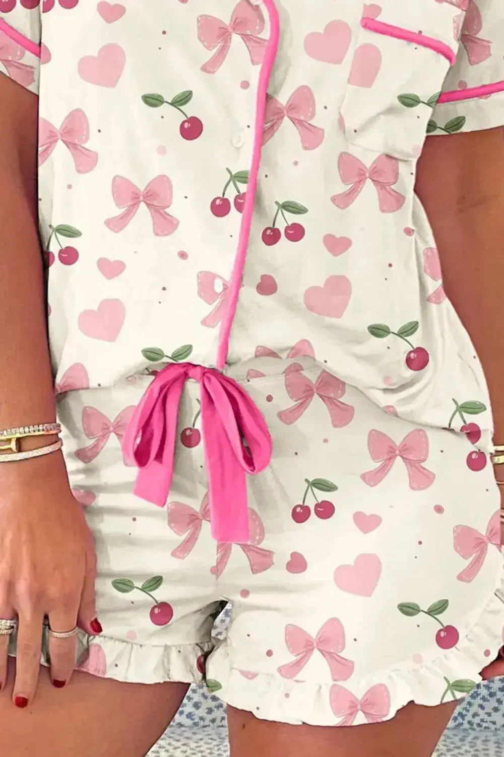 Women's printed button-up short sleeve pajama top and shorts lounge set by Trendsi, featuring a comfortable and stylish sleepwear design.