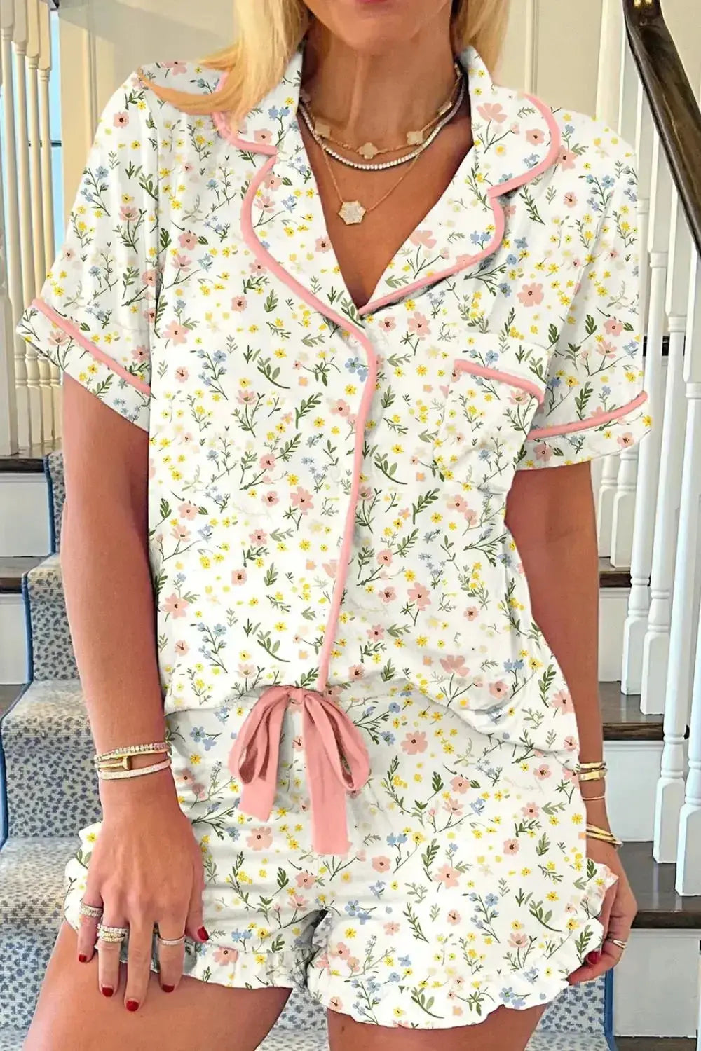 Women's printed button-up short sleeve pajama top and shorts lounge set by Trendsi, featuring floral design and comfortable fabric.