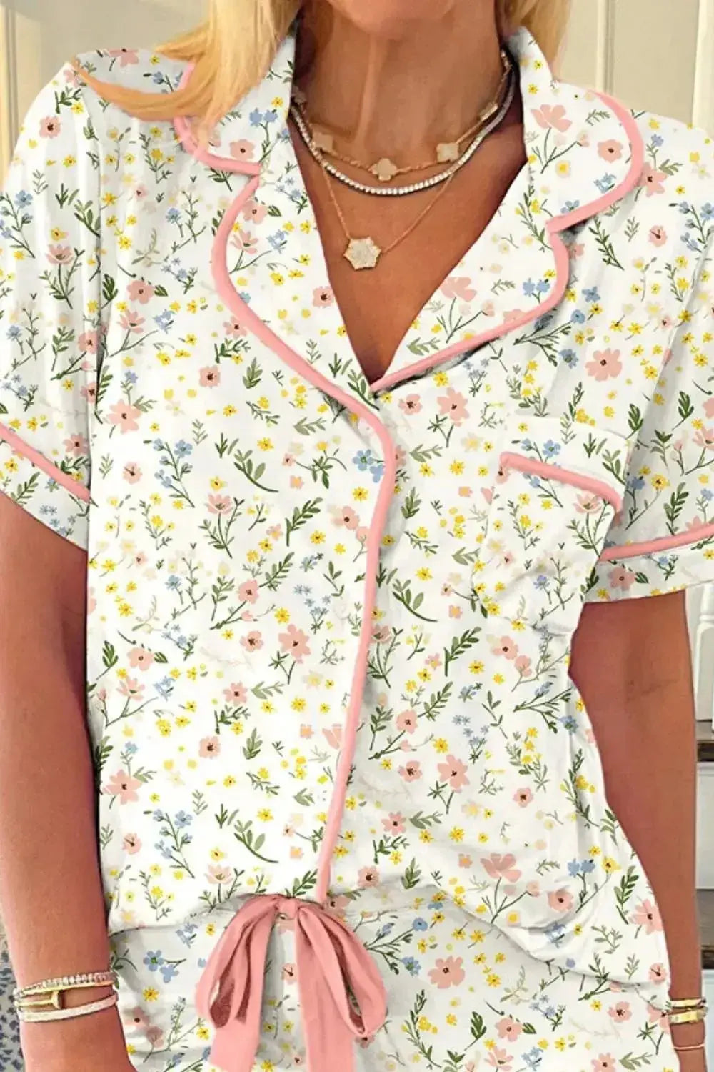 Women’s printed button-up short sleeve pajama top and shorts lounge set by Trendsi, featuring a comfortable, relaxed fit and floral pattern.