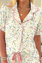 Women’s printed button-up short sleeve pajama top and shorts lounge set by Trendsi, featuring a comfortable, relaxed fit and floral pattern.