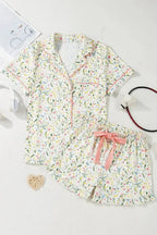 Women's printed button-up short sleeve pajama top and shorts lounge set by Trendsi, featuring a comfortable, stylish sleepwear ensemble.