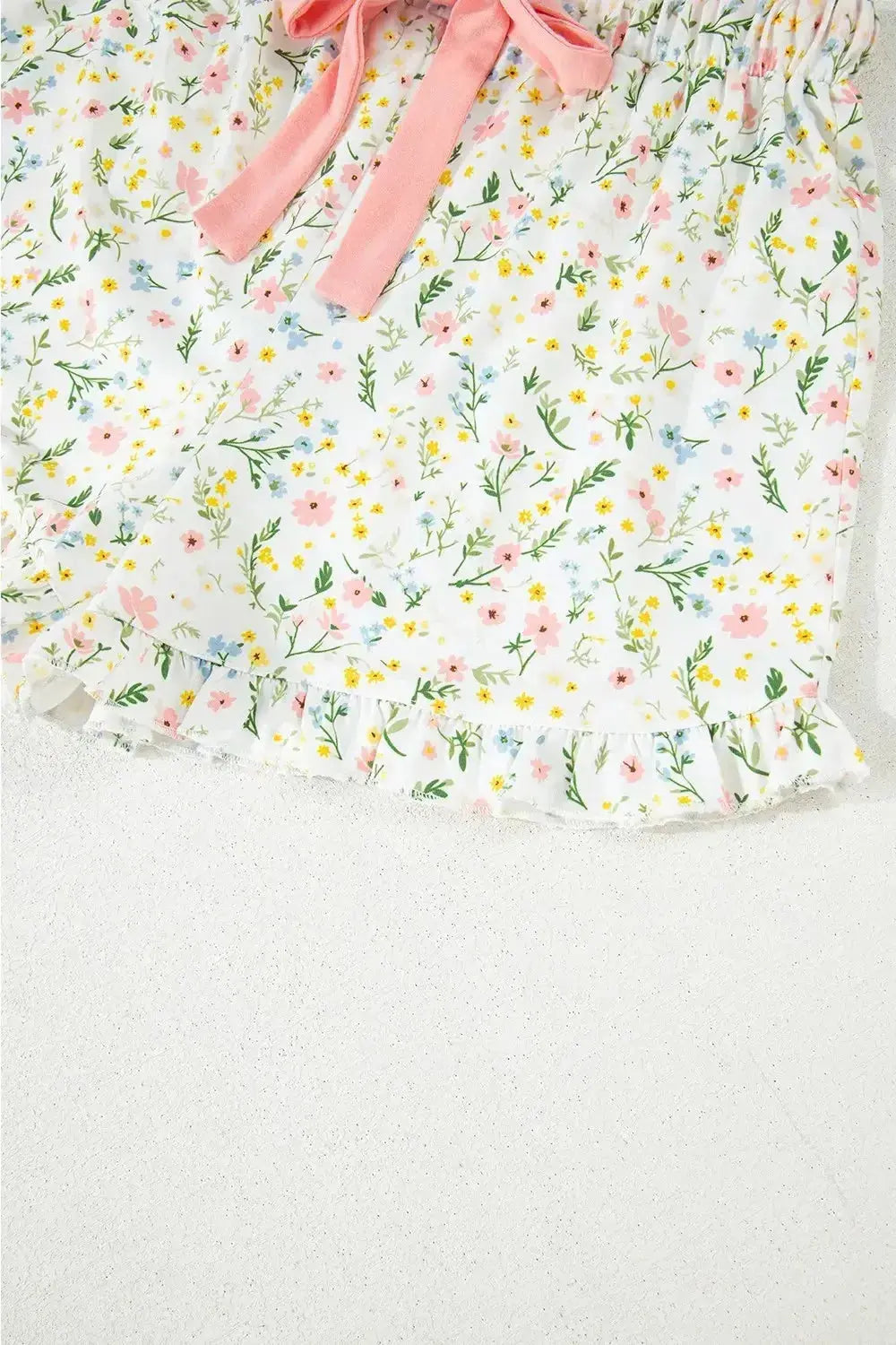 Women's printed button-up short sleeve pajama top and shorts lounge set by Trendsi, featuring a comfortable and stylish sleepwear ensemble.
