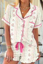 Women's printed pajama set by Trendsi featuring a button-up short-sleeve top and matching shorts for comfortable lounge wear.