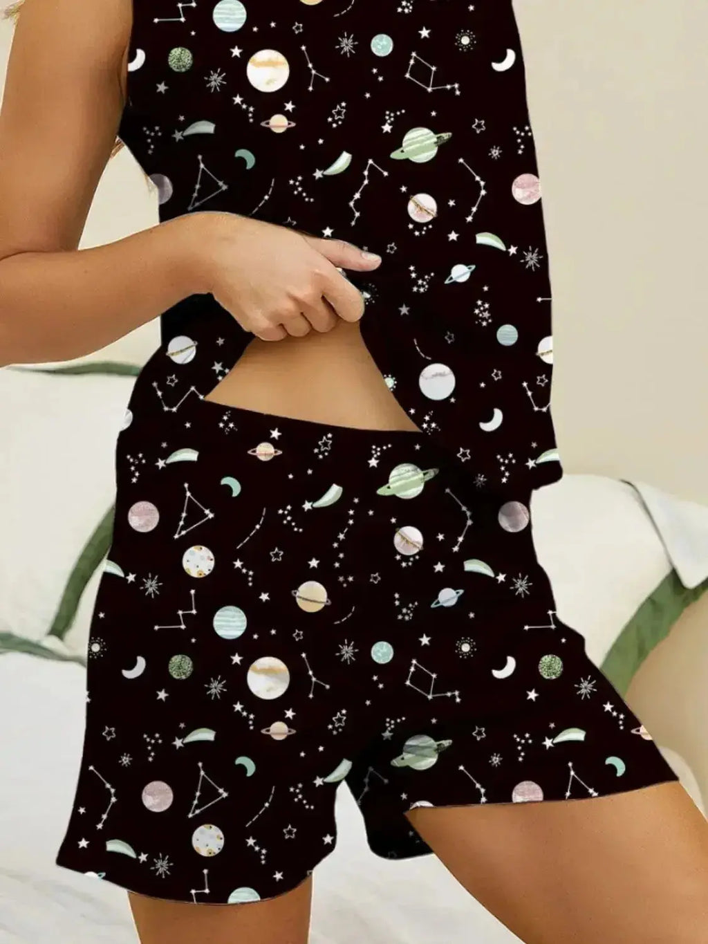 Women’s printed round neck pajama top and shorts lounge set by Trendsi, soft fabric, comfortable sleepwear ensemble.