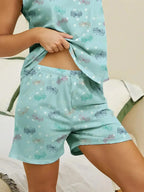 Women’s printed round neck pajama top and shorts lounge set by Trendsi, featuring comfortable fabric and stylish design.