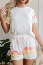 Women's rainbow striped round neck T-shirt and shorts lounge set, casual pajama ensemble by Trendsi, featuring colorful stripes and soft fabric.