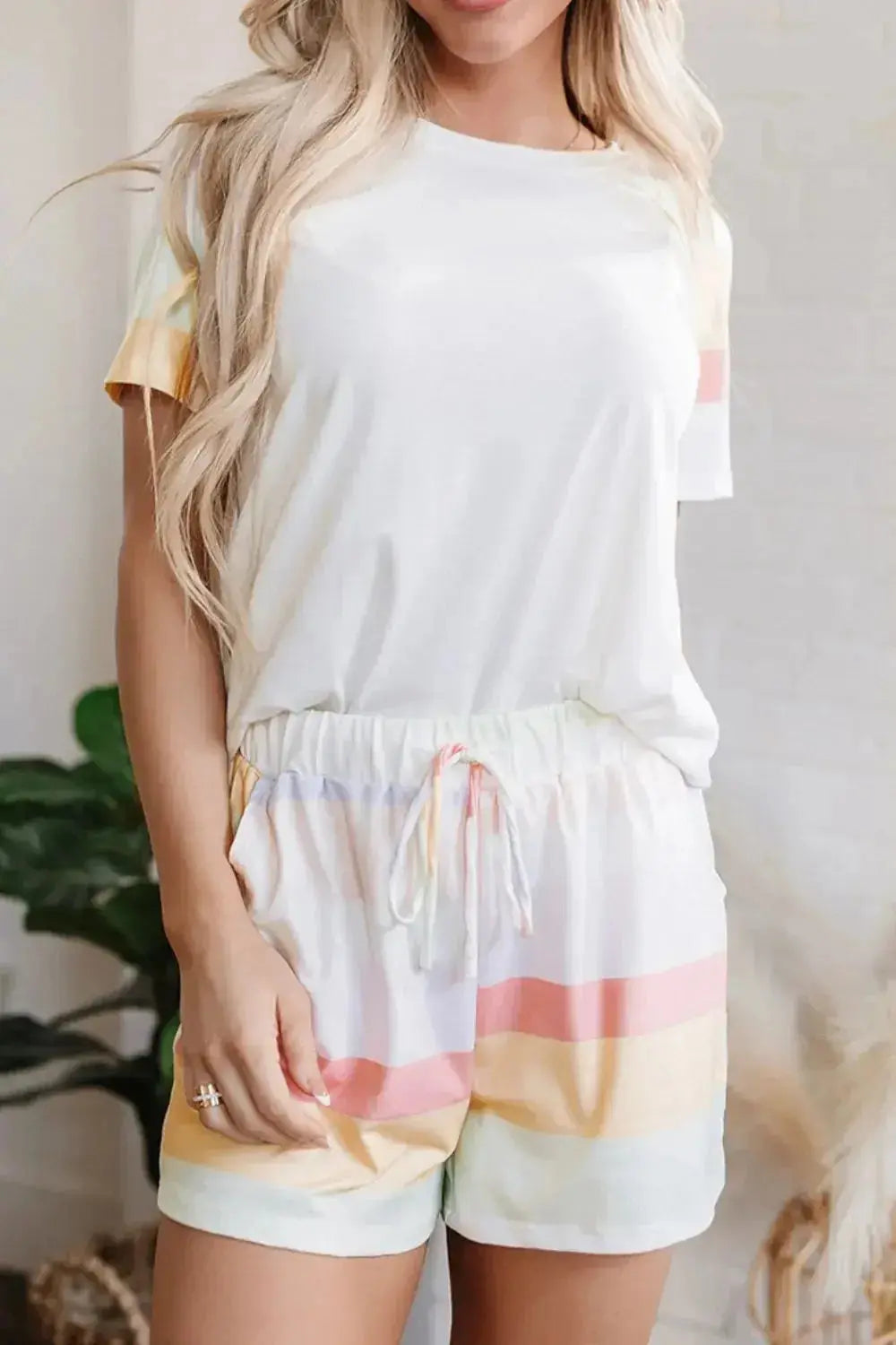 Women's rainbow striped round neck T-shirt and shorts lounge set, casual pajama set by Trendsi with colorful pattern.