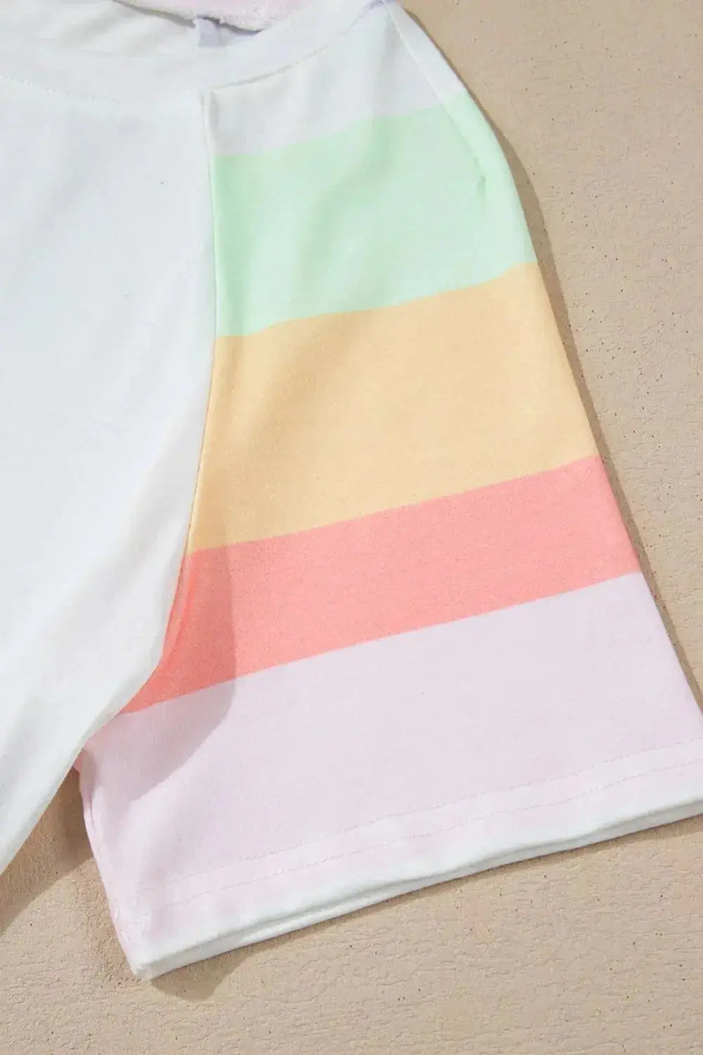 Women's rainbow striped round neck T-shirt and shorts lounge set, casual pajamas by Trendsi, featuring colorful striped fabric.