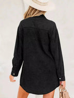 Women’s raw hem denim shirt dress by Trendsi with long sleeves, button-down front, and cotton fabric, styled for casual wear.