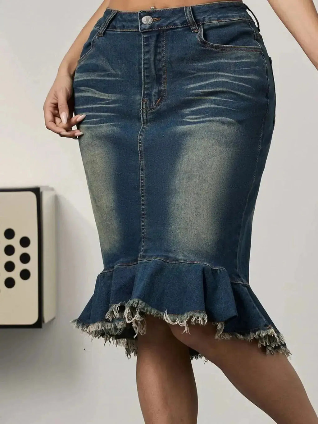 Women's raw hem mermaid denim midi skirt by Trendsi, featuring stretchy blue jean fabric and a fitted silhouette.