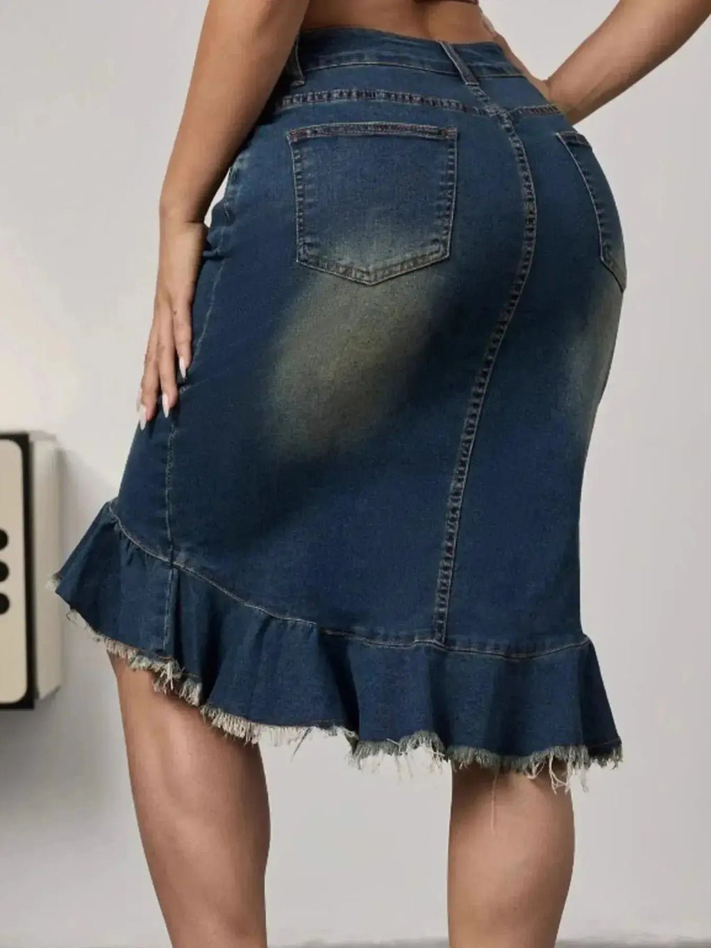 Women's raw hem mermaid denim midi skirt by Trendsi featuring a stretchy blue jean silhouette and stylish raw hem detail.