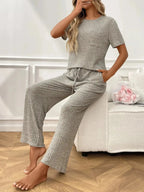 Women's ribbed knit short sleeve loungewear set with pockets, comfortable pajamas by Trendsi, ideal for relaxing at home.