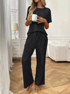 Women’s ribbed knit short sleeve loungewear set with pockets, comfortable pajamas by Trendsi, perfect for relaxed home wear.