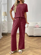 Women's ribbed knit short sleeve pajama set with pockets, comfortable loungewear by Trendsi, perfect for relaxing at home.