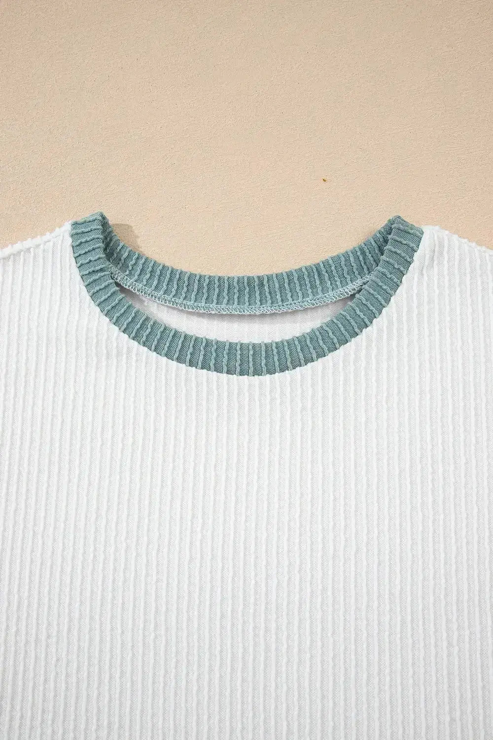 Women's ribbed knit sleeveless tank top with contrast trim, soft fitted shirt by Trendsi, shown in a close-up view of the design.