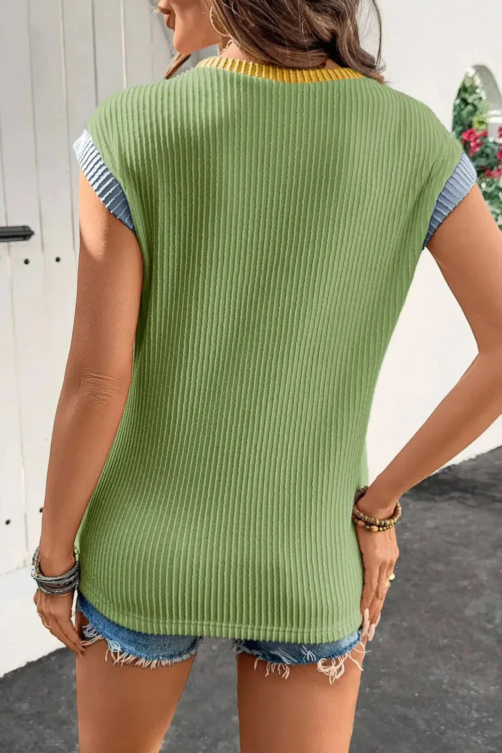 Women's ribbed knit sleeveless tank top with contrast trim, soft fitted shirt by Trendsi, showcasing the neckline and trim details.