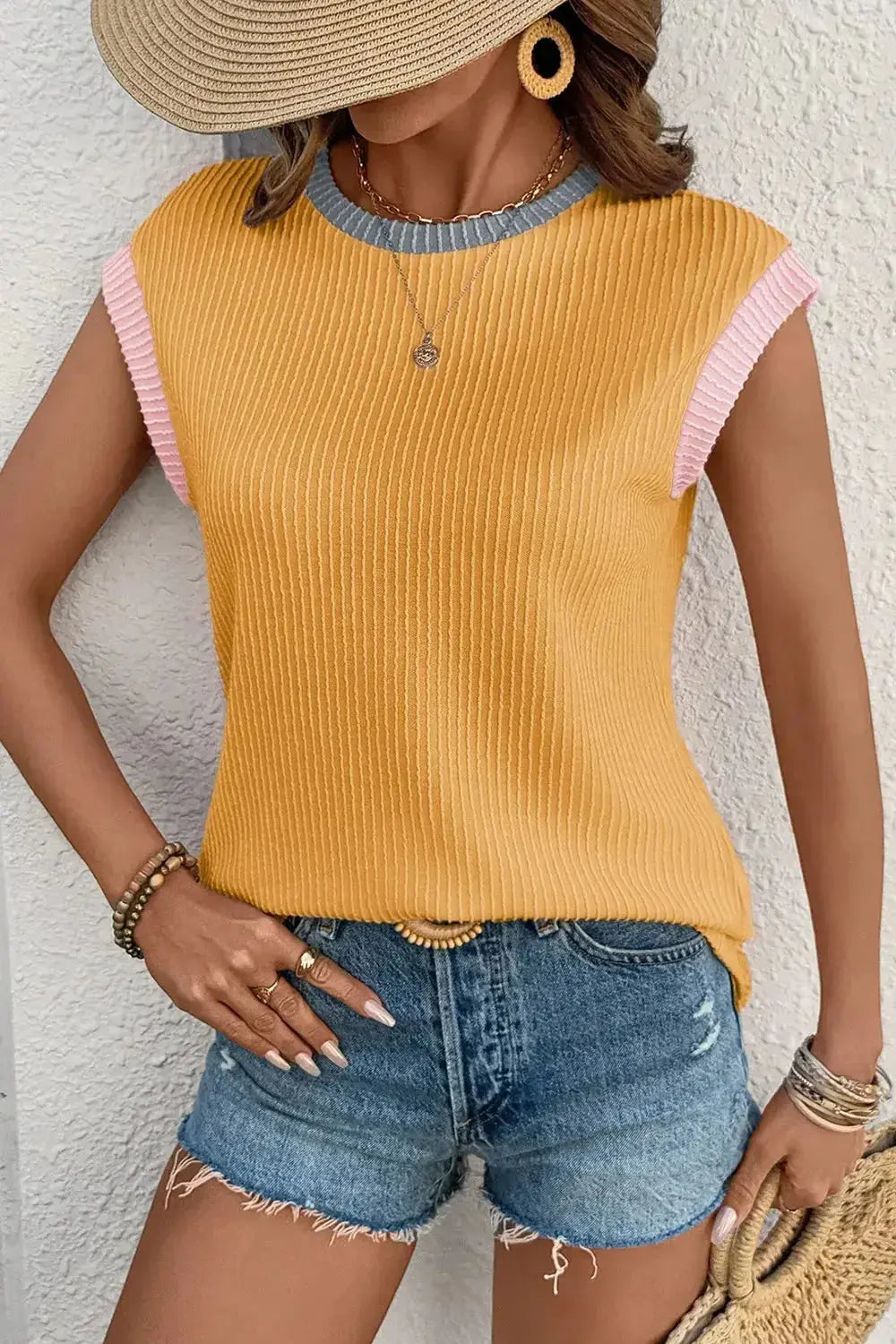 Women's ribbed knit sleeveless top with contrast trim, soft fitted tank shirt by Trendsi, shown in a close-up of the fabric and design details.