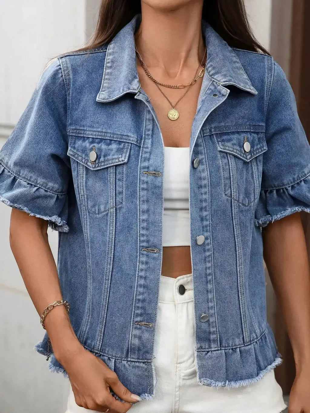Women’s ruffled raw hem button-up denim jacket from Trendsi, featuring classic denim fabric and stylish ruffle details.