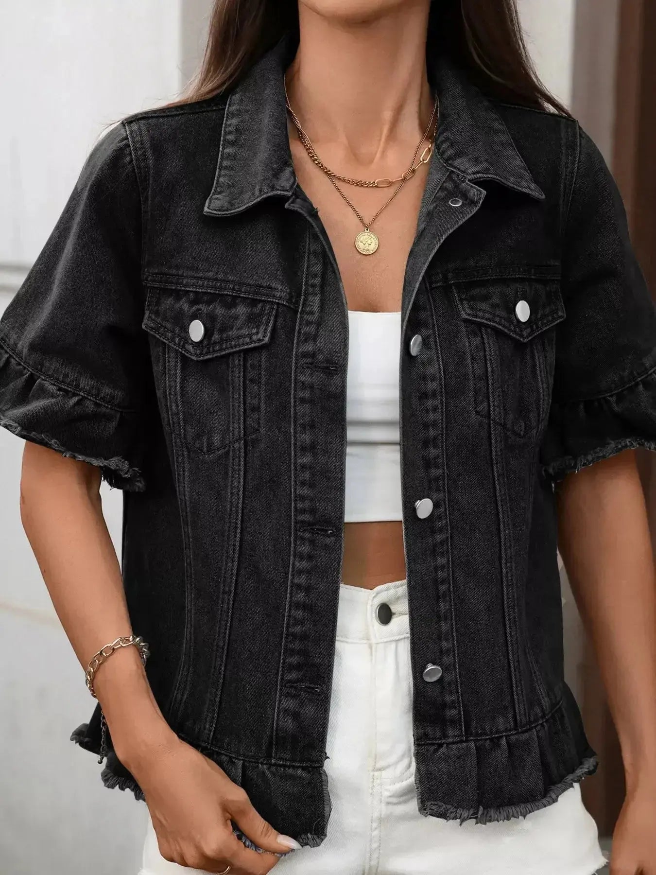 Women’s ruffled raw hem button-up denim jacket by Trendsi, featuring a stylish distressed denim design with ruffle details.