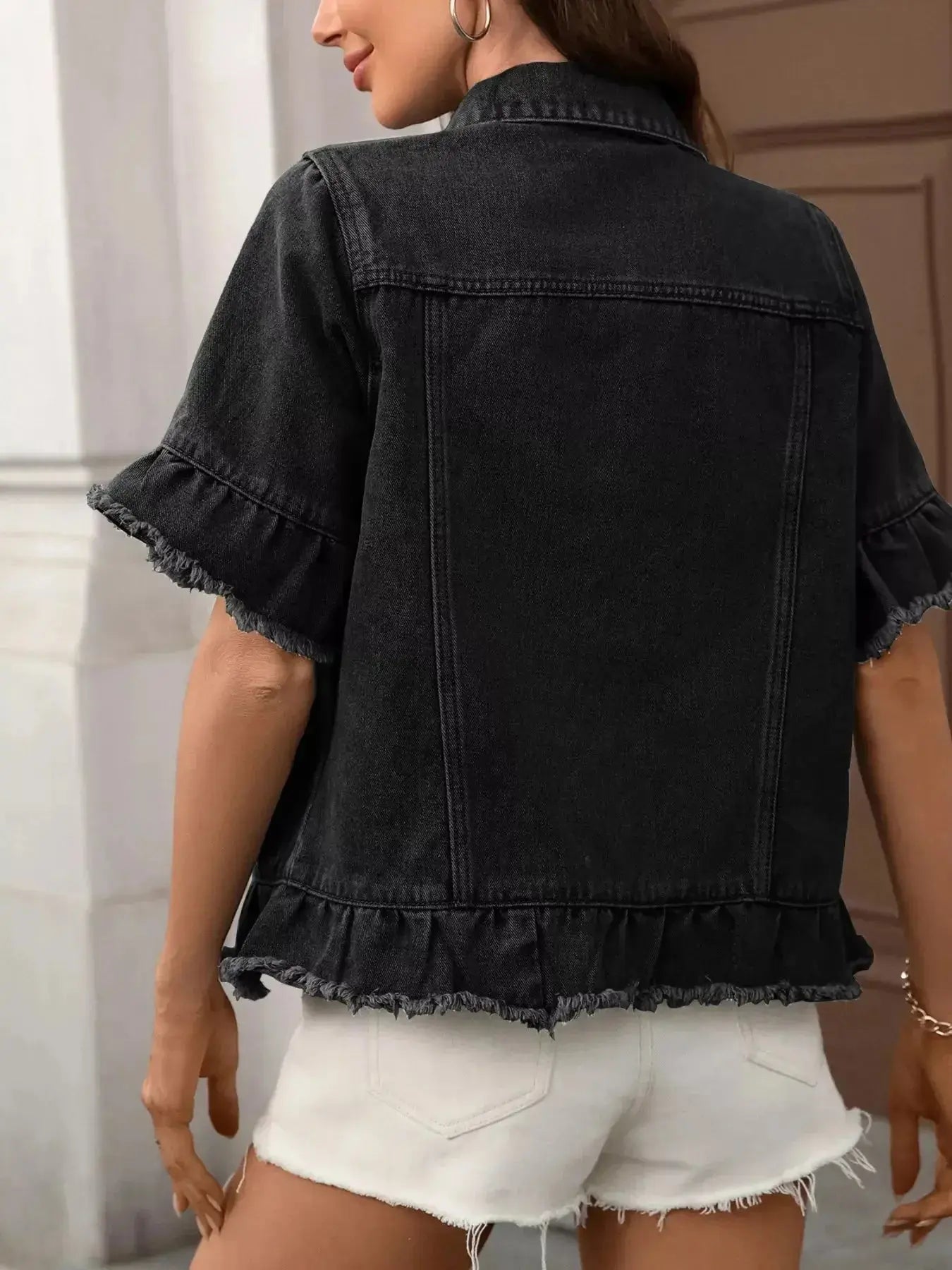 Women’s ruffled raw hem button-up denim jacket by Trendsi, featuring distressed denim and ruffle details, styled on a model.