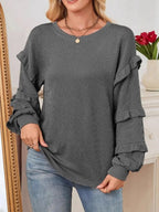 Women’s ribbed long sleeve sweatshirt with ruffled round neckline, trendy sweater from Trendsi featuring a casual, stylish design.