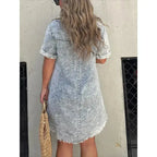 Women’s short sleeve denim button-down dress with raw hem in a casual style by Plush Fashion Hub.